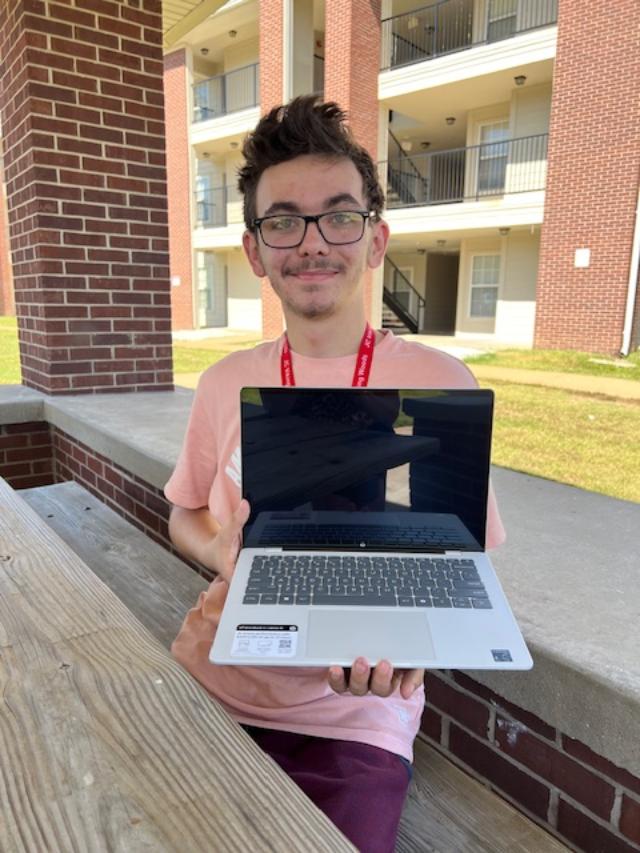 Logan receiving his laptop from HYI